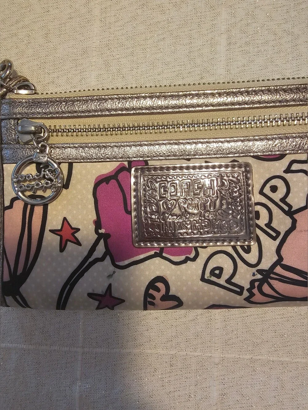 Coach Poppy pink floral graffiti print and metallic silver trim wristlet